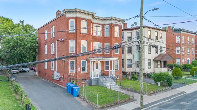 a view of a large building next to a yard