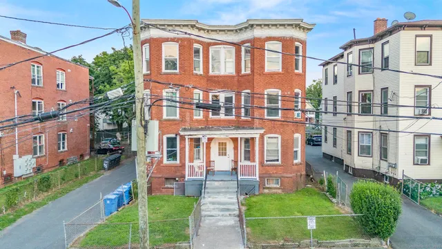 a front view of a residential apartment building with a yard