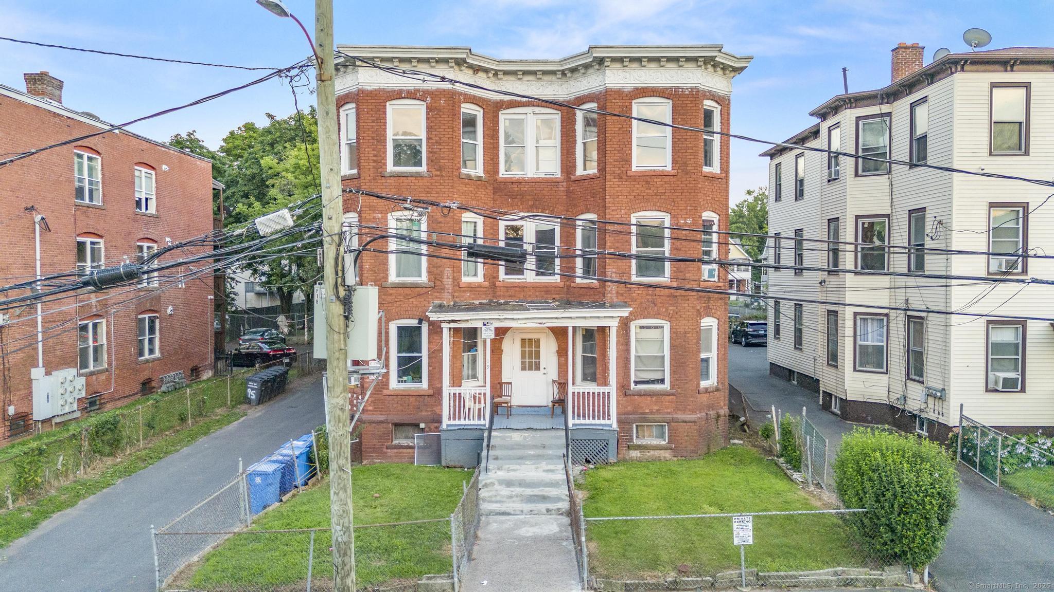 19 Whitmore Street Hartford, CT 06114 - Photo 23 of 27 a front view of a residential apartment building with a yard