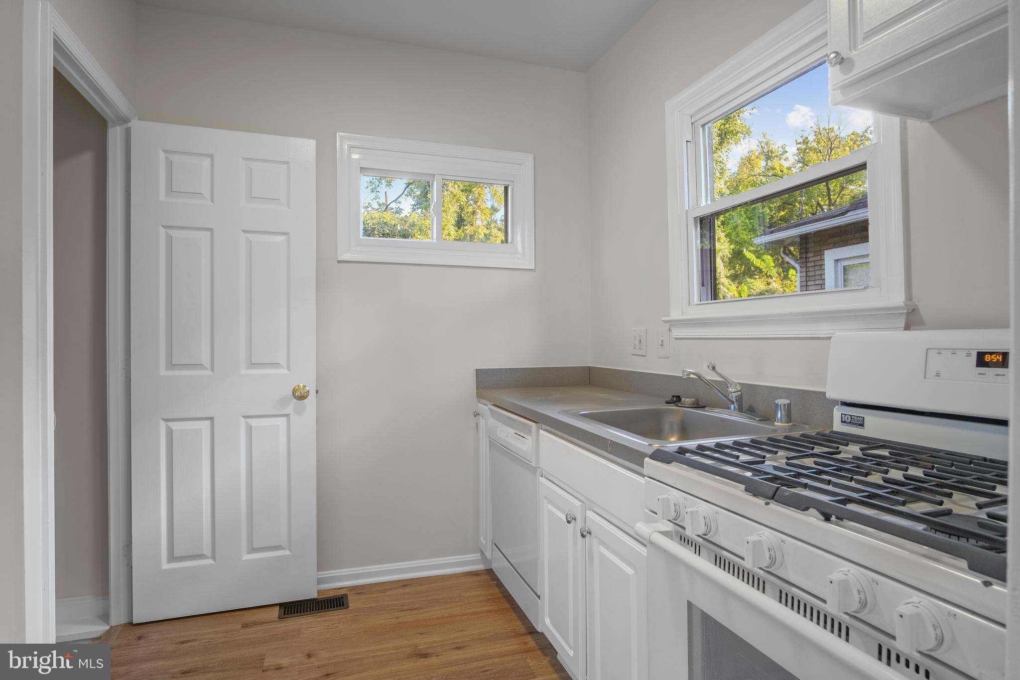217 Peabody Street Northwest Washington, DC 20011 - Photo 13 of 27 a kitchen with granite countertop a sink and a stove next to a window