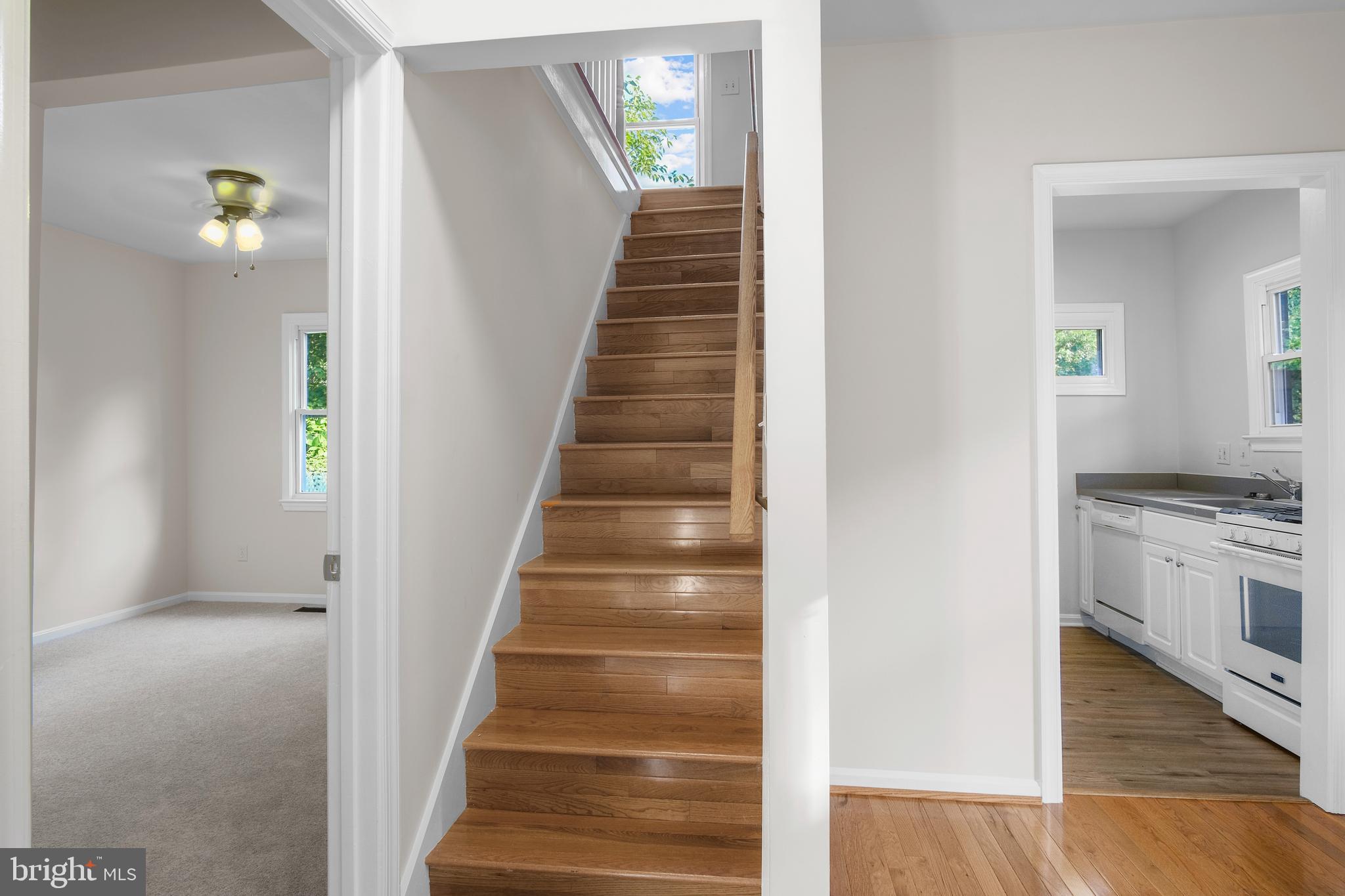 217 Peabody Street Northwest Washington, DC 20011 - Photo 19 of 27 a view of an entryway with wooden floor and a living room