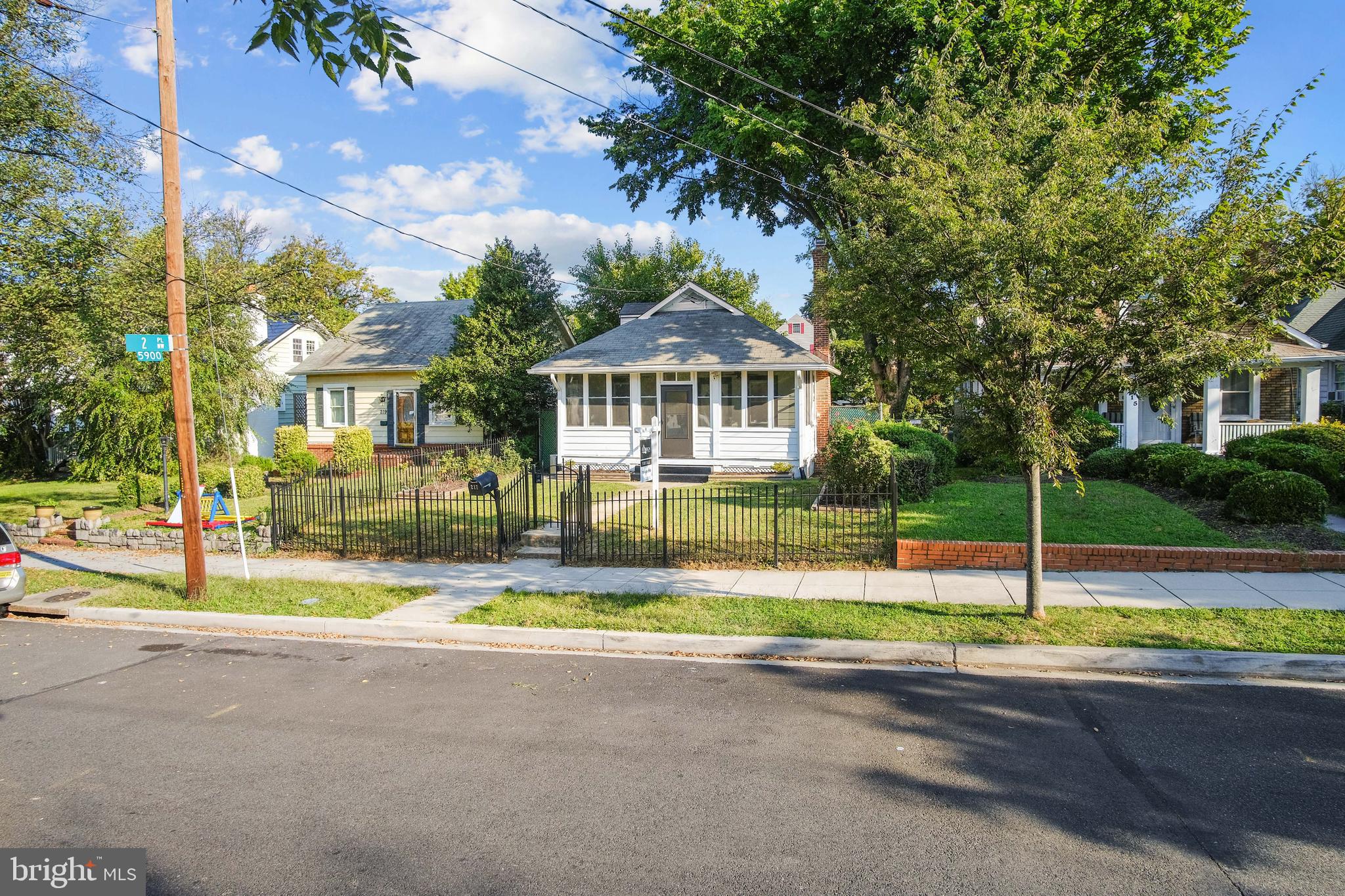 217 Peabody Street Northwest Washington, DC 20011 - Photo 5 of 27 a front view of a house with a garden and tree