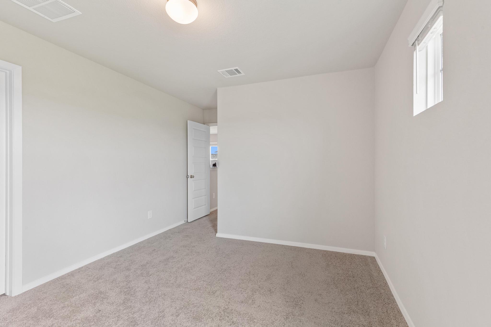 242 Barley Lane Elgin, TX 78621 - Photo 22 of 31 Carpeted room with neutral wall tones and white baseboards