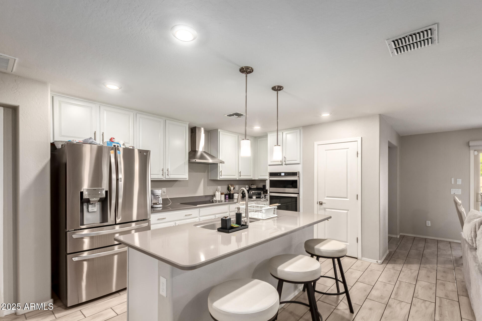 1133 South Rico Mesa, AZ 85204 - Photo 11 of 36 a kitchen with refrigerator and chairs