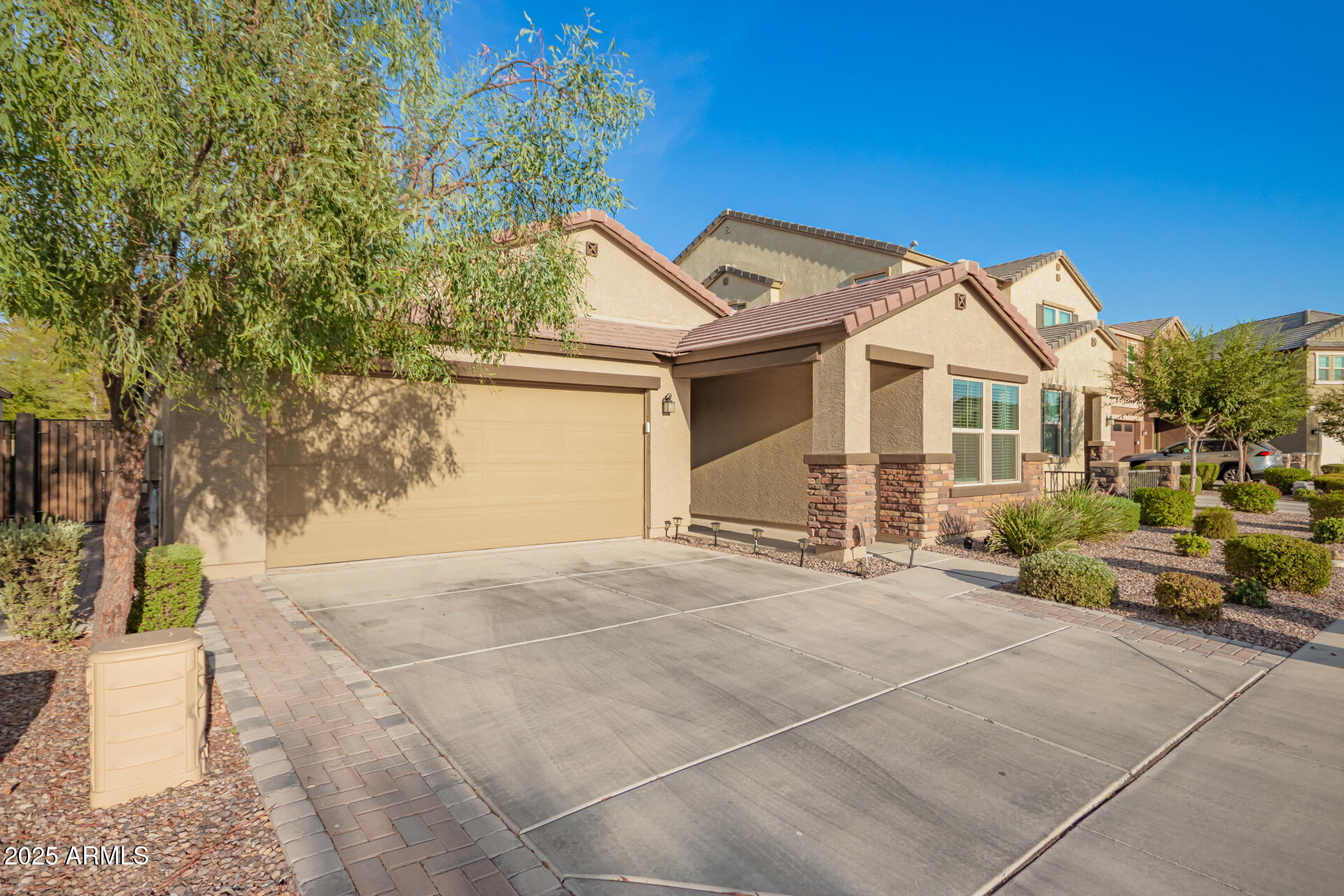 1133 South Rico Mesa, AZ 85204 - Photo 3 of 36 a view of a white house next to a yard with potted plants