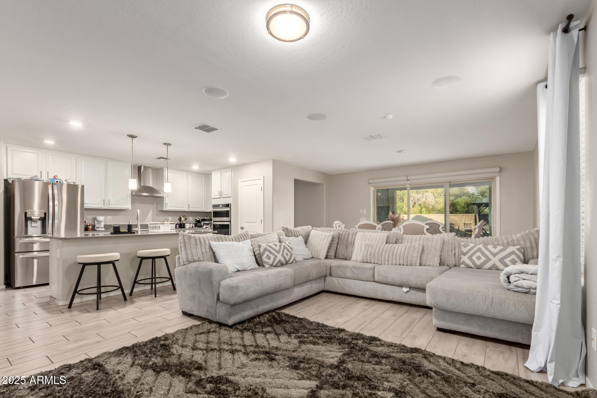 1133 South Rico Mesa, AZ 85204 - Photo 9 of 36 a living room with furniture white walls and a view of kitchen