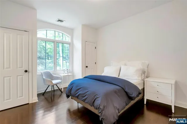 a bedroom with a bed and a table