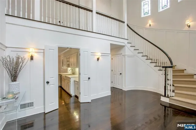 a view of entryway with wooden floor and stairs