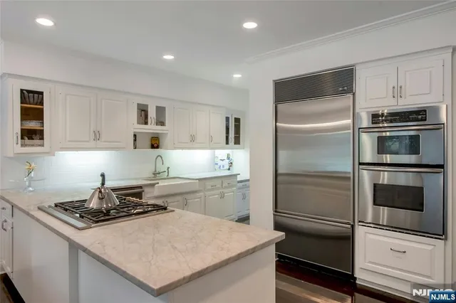 a kitchen with a refrigerator stove and microwave