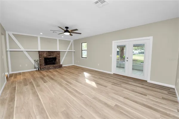 wooden floor in an empty room with a fireplace