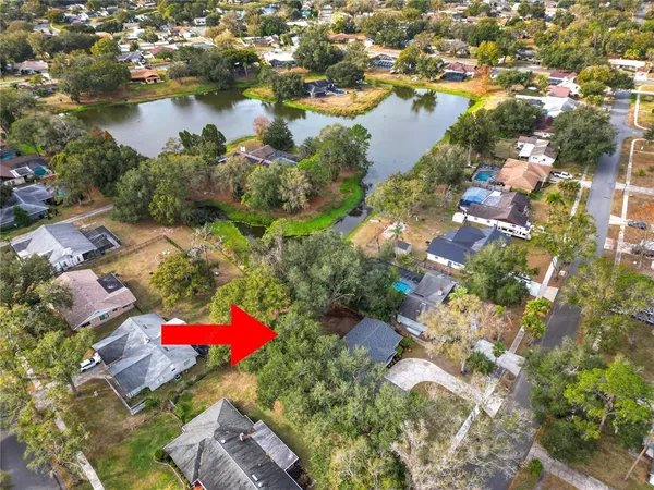 an aerial view of residential houses with outdoor space and river