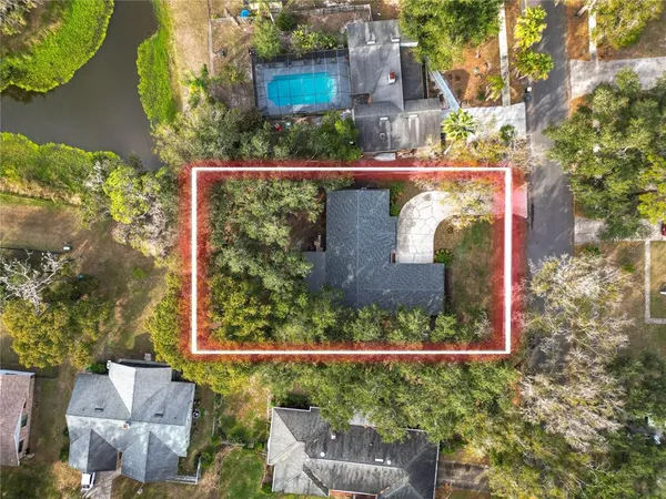 an aerial view of a house with a yard and outdoor seating