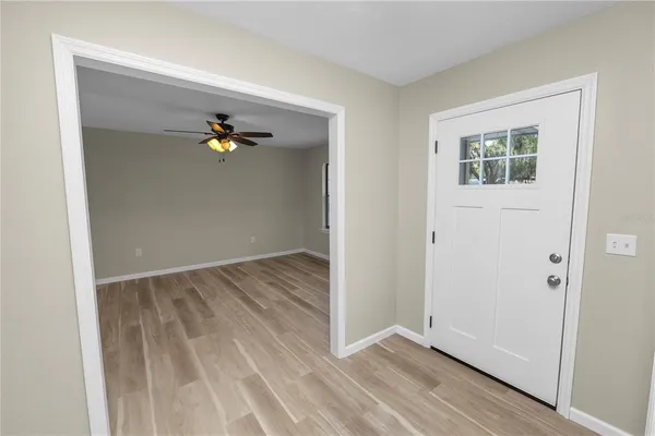 an empty room with wooden floor cabinet and closet