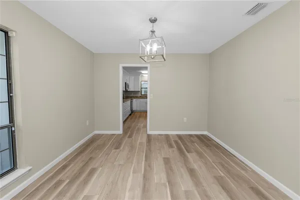 a view of a room with wooden floor water and a window