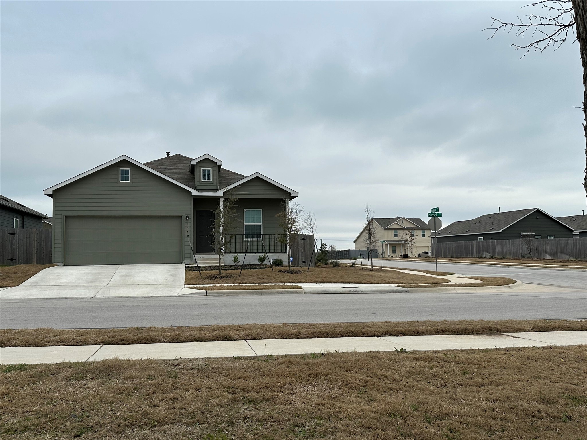 13501 Mussel Run Elgin, TX 78621 - Photo 28 of 28 Single-story residence featuring a two-car garage and a covered front porch
