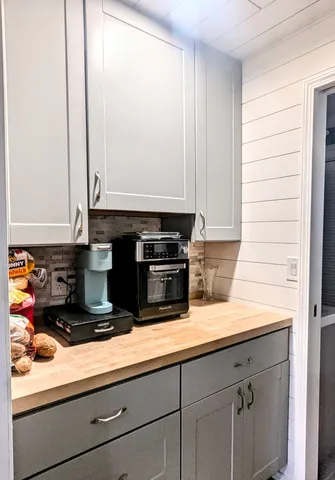 a kitchen with stainless steel appliances granite countertop white cabinets and a granite counter tops