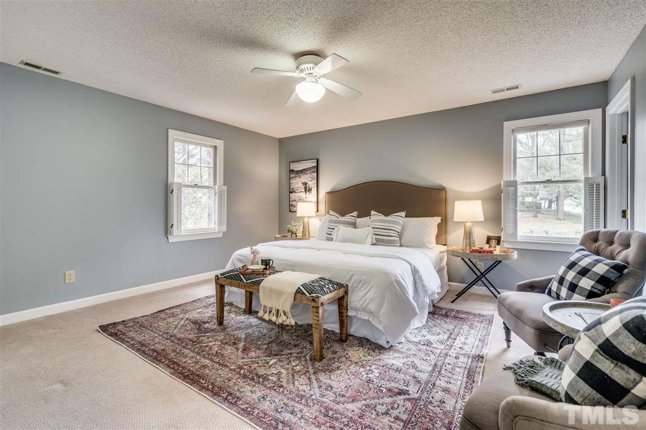 1 Swallows Ridge Court Durham, NC 27713 - Photo 17 of 26 a bedroom with a bed and wooden floor