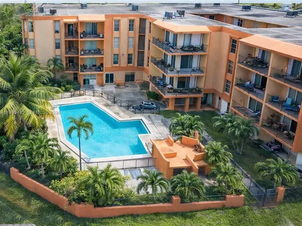 an aerial view of a house with a swimming pool patio and outdoor seating