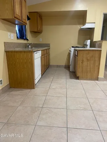 a kitchen with a stove top oven cabinets and a counter top space