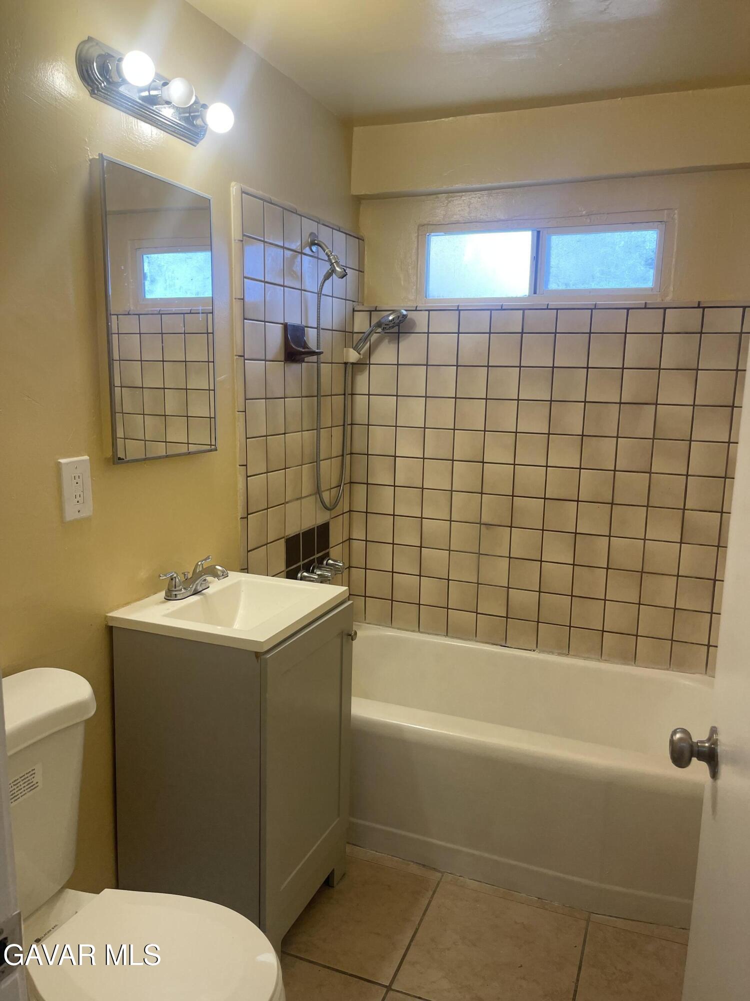 2004 Oldfield Street, Unit B Lancaster, CA 93536 - Photo 8 of 12 a bathroom with a sink toilet and shower