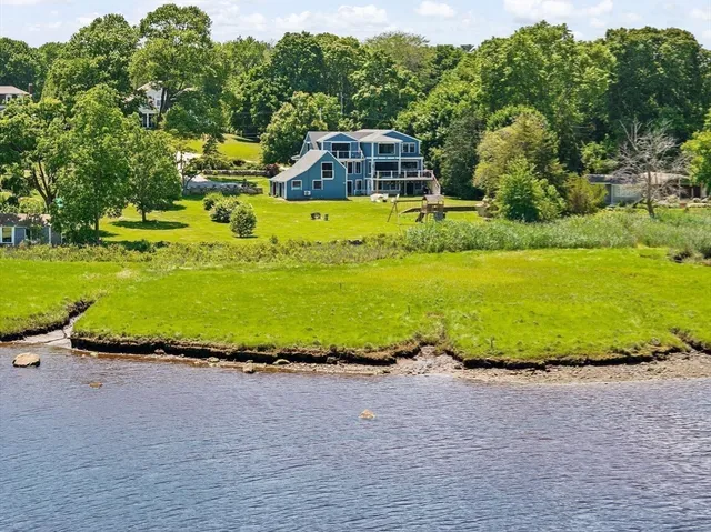 an aerial view of a house with garden space and outdoor seating