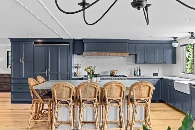 a spacious bathroom with a double vanity sink a mirror and a bathtub