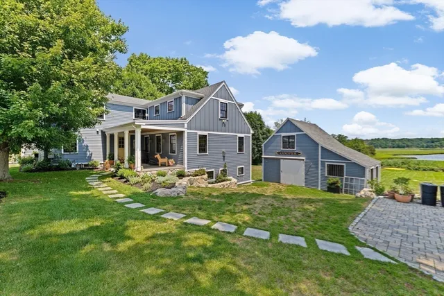 a living room with furniture a flat screen tv and a floor to ceiling window