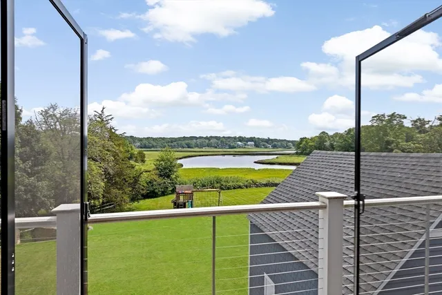 a kitchen with stainless steel appliances granite countertop a table chairs in it and wooden floors