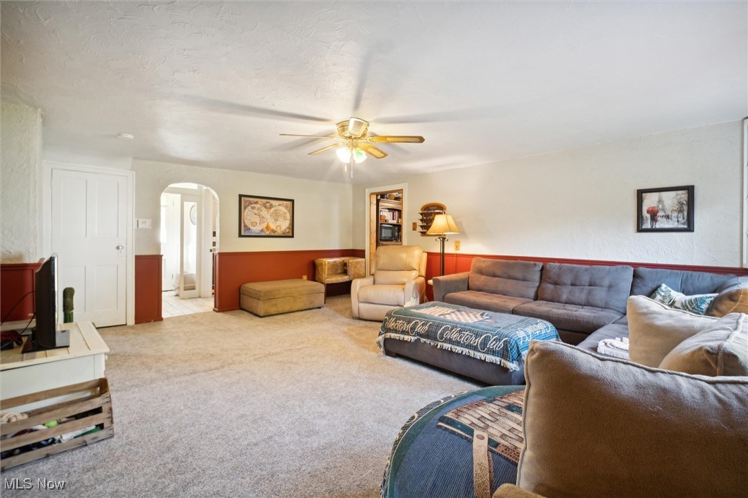 13930 Carter Road Wakeman, OH 44889 - Photo 10 of 45 Carpeted living room featuring ceiling fan and a textured ceiling