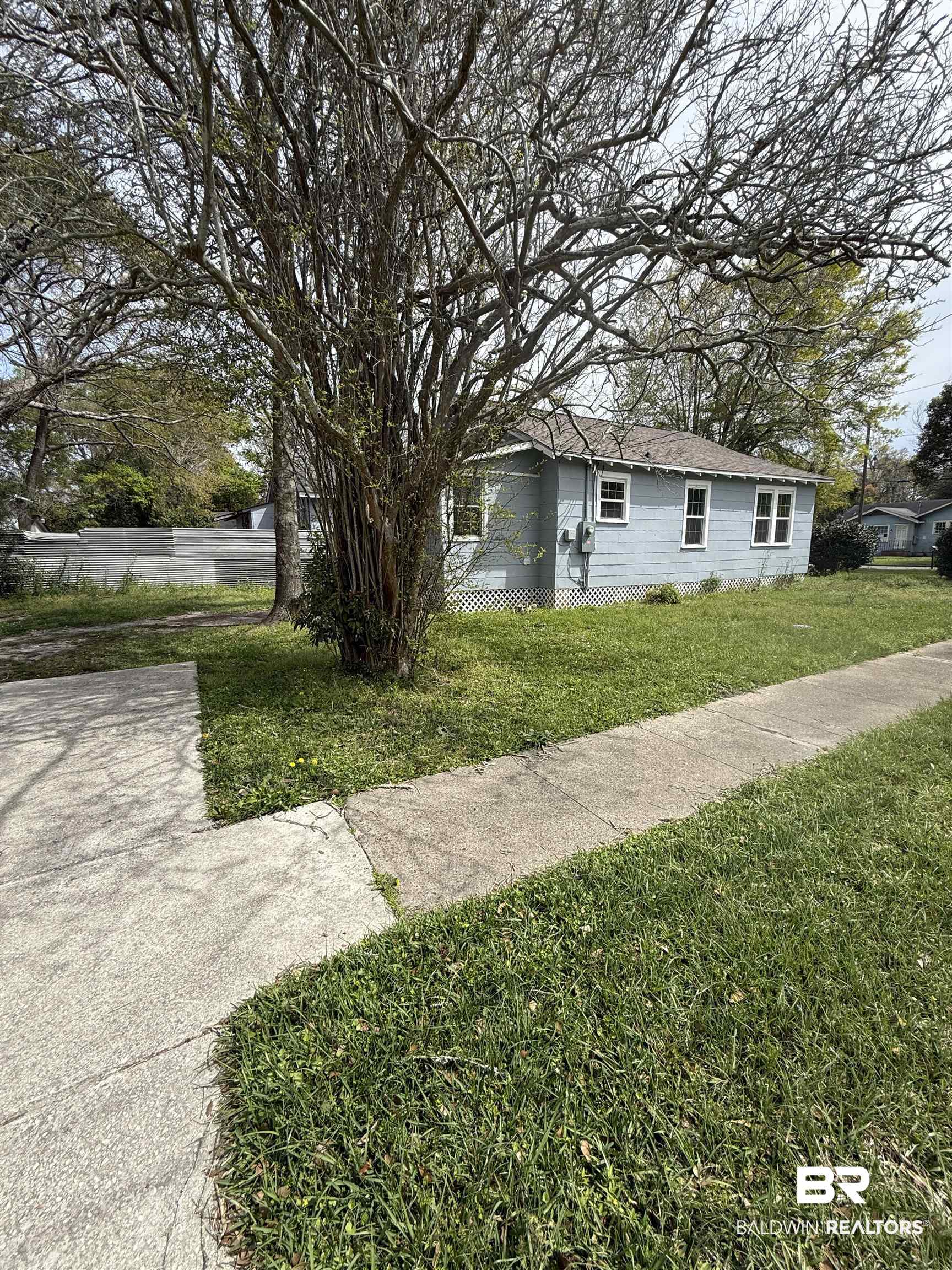 1848 Canal Street Mobile, AL 36606 - Photo 11 of 11 View of home's exterior with a lawn