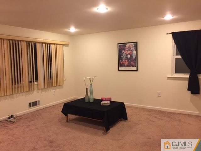 23 Richmond Road Edison, NJ 08817 - Photo 4 of 13 a living room with furniture and a flat screen tv