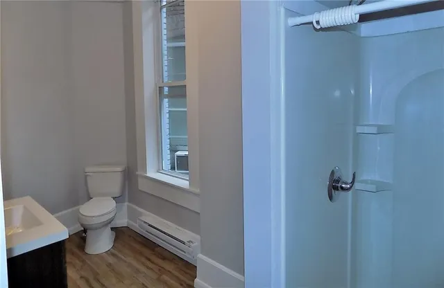 a bathroom with a toilet and a shower