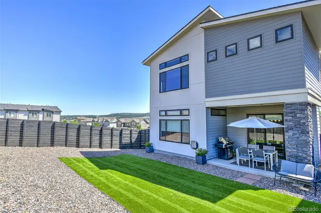 a view of a house with a yard and sitting area