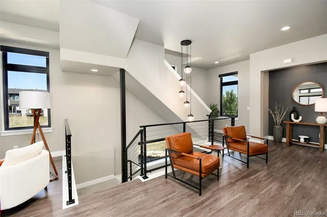a living room with furniture and a floor to ceiling window