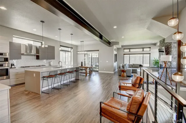 a large white kitchen with lots of counter space dining table and chairs