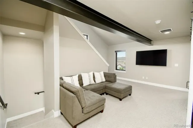 a spacious bedroom with a bed and large windows