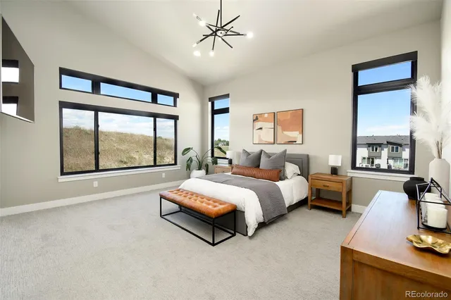 a bedroom with a bed and a large window