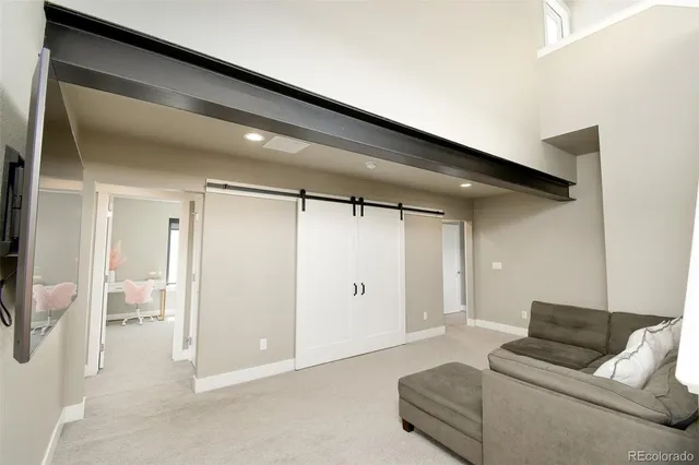 a living room with furniture and a walk in closet
