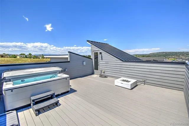 a terrace of a house with wooden floor and city view