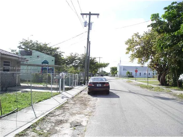 a view of yard with swimming pool and seating area