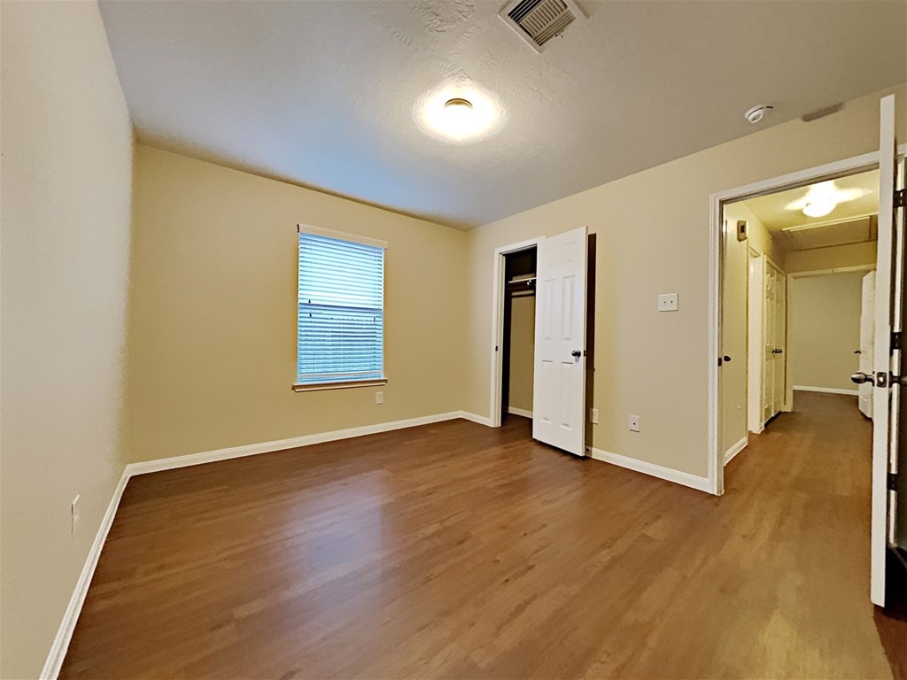 21535 Micheala Way Humble, TX 77338 - Photo 11 of 17 an empty room with wooden floor and windows