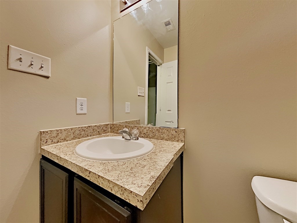 21535 Micheala Way Humble, TX 77338 - Photo 12 of 17 a bathroom with a granite countertop sink and a mirror