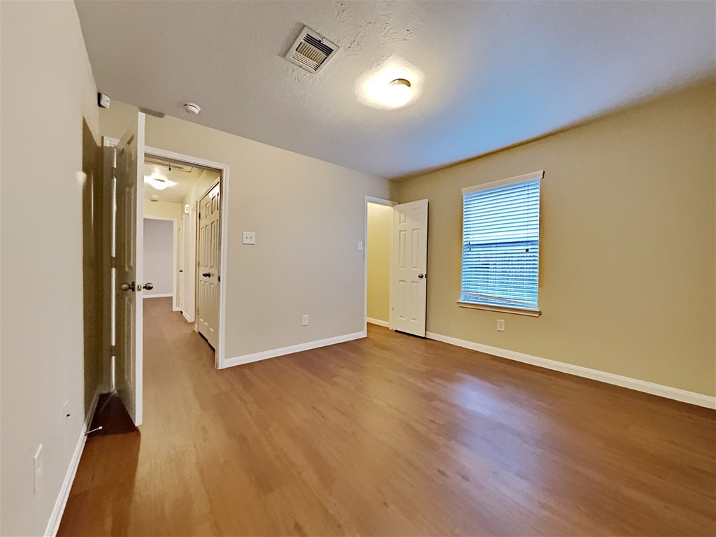21535 Micheala Way Humble, TX 77338 - Photo 14 of 17 wooden floor in an empty room with a window