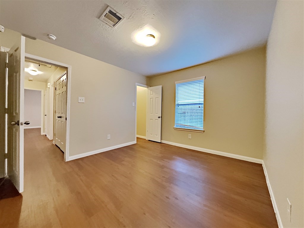 21535 Micheala Way Humble, TX 77338 - Photo 15 of 17 an empty room with wooden floor and windows