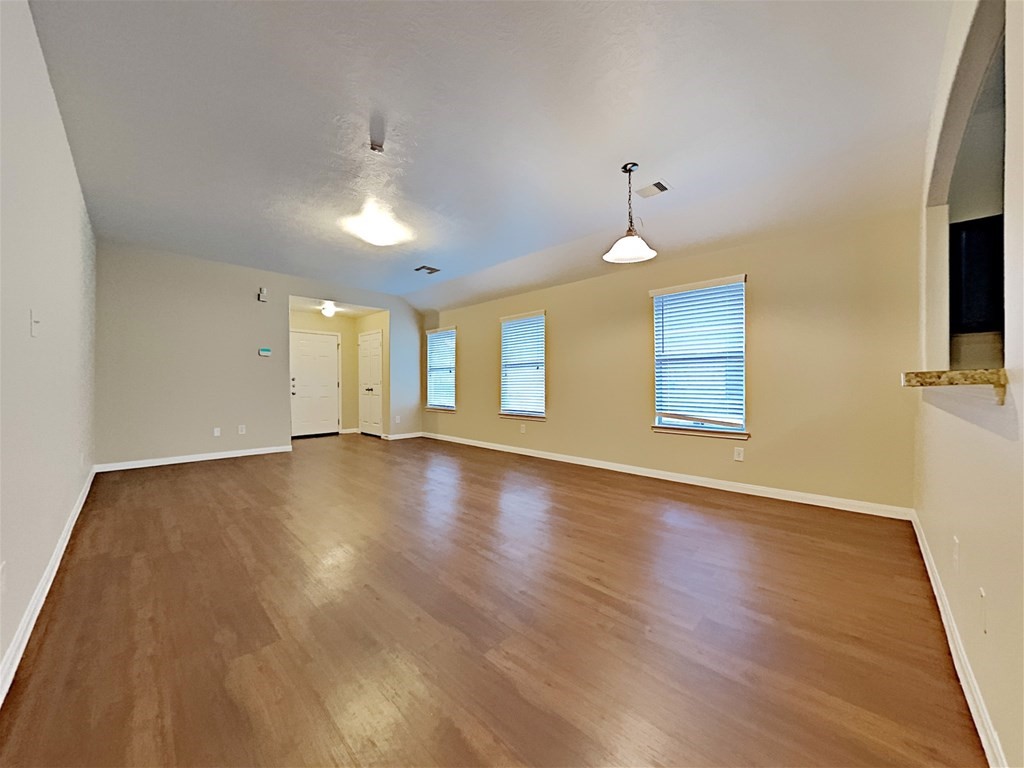 21535 Micheala Way Humble, TX 77338 - Photo 4 of 17 a view of an empty room with a window and wooden floor