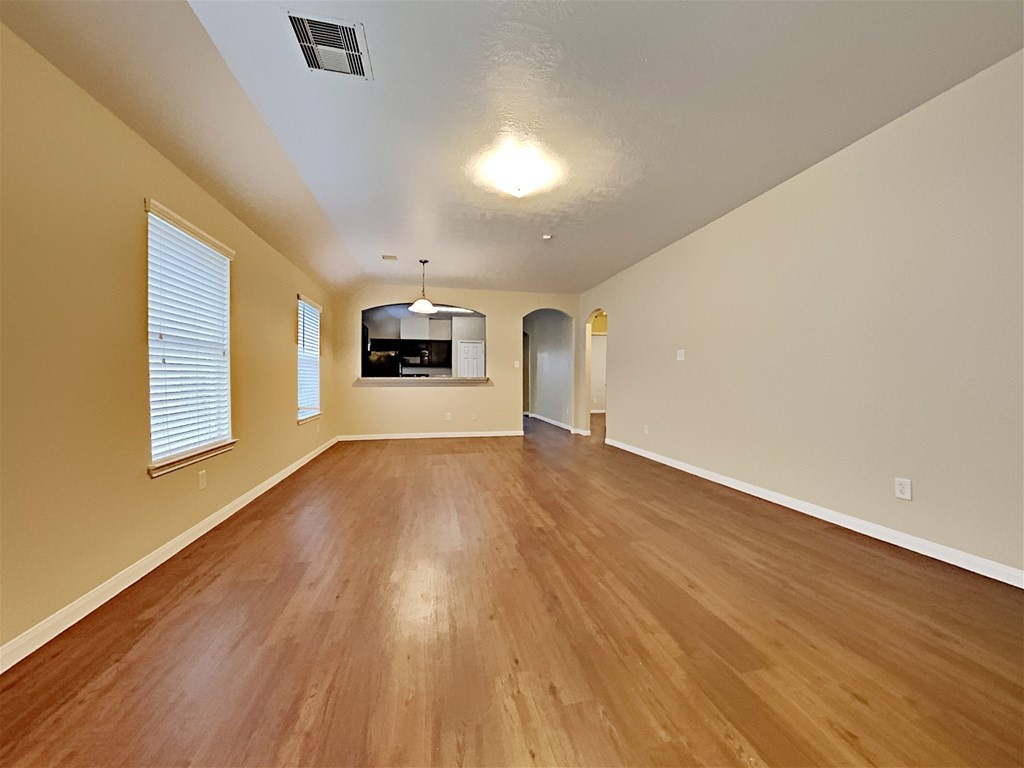 21535 Micheala Way Humble, TX 77338 - Photo 5 of 17 wooden floor in an empty room with a window