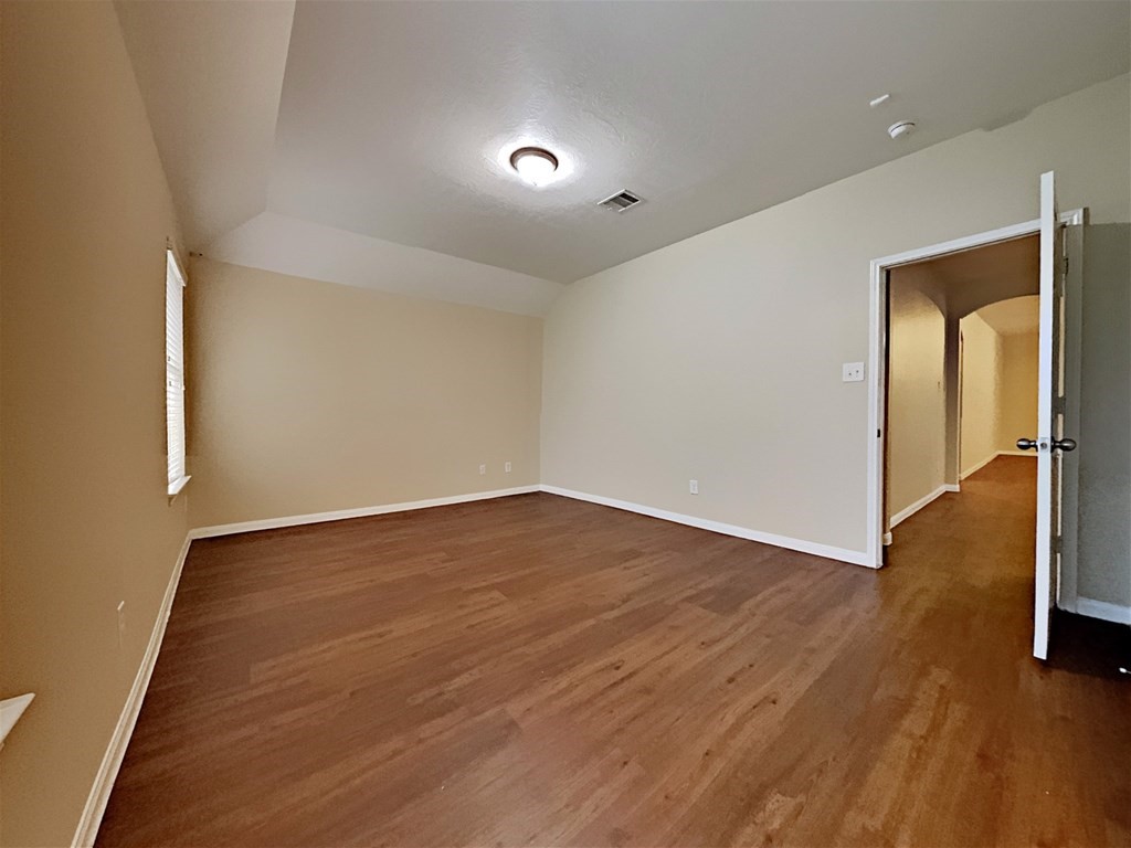 21535 Micheala Way Humble, TX 77338 - Photo 7 of 17 wooden floor in an empty room with a window