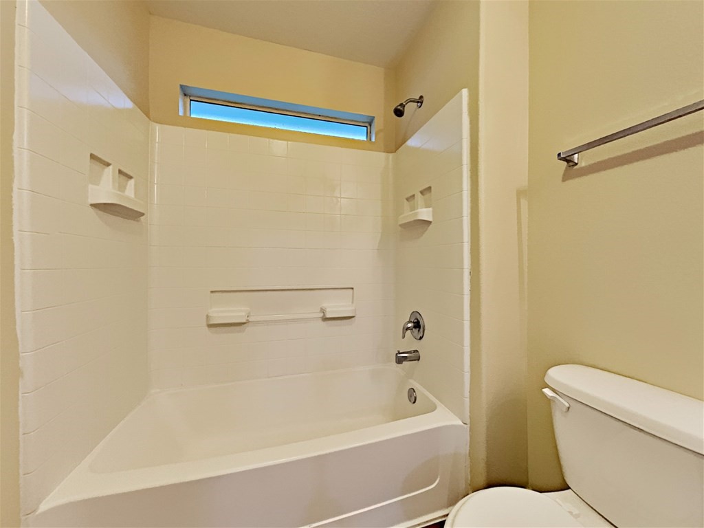 21535 Micheala Way Humble, TX 77338 - Photo 9 of 17 a bathroom with a toilet and a bath tub