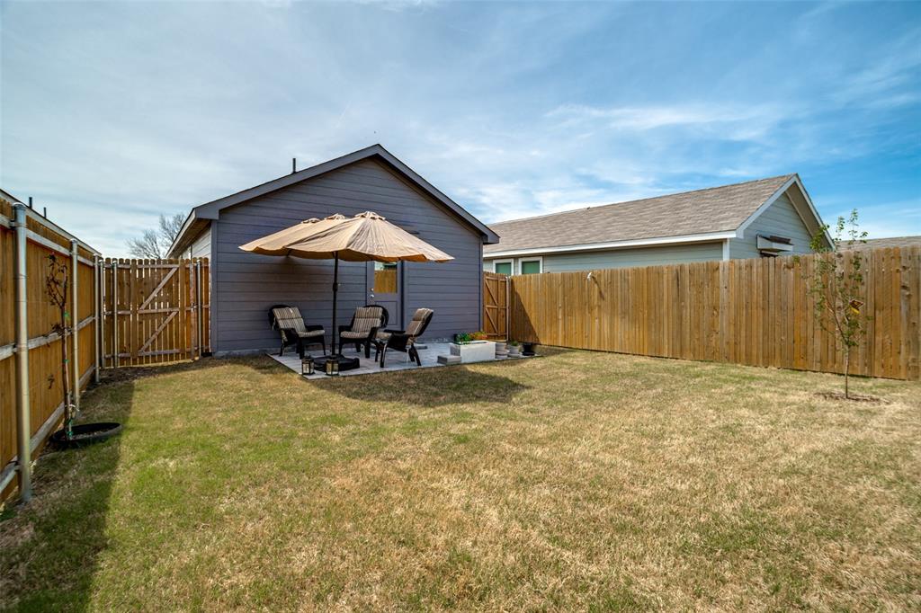142 Sesame Lane Princeton, TX 75407 - Photo 14 of 15 a view of a house with chairs and table under an umbrella