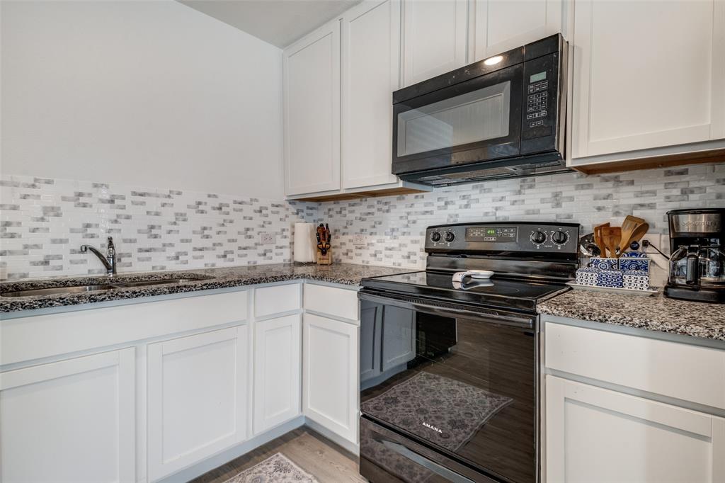 142 Sesame Lane Princeton, TX 75407 - Photo 6 of 15 a kitchen with stainless steel appliances granite countertop a sink stove and microwave